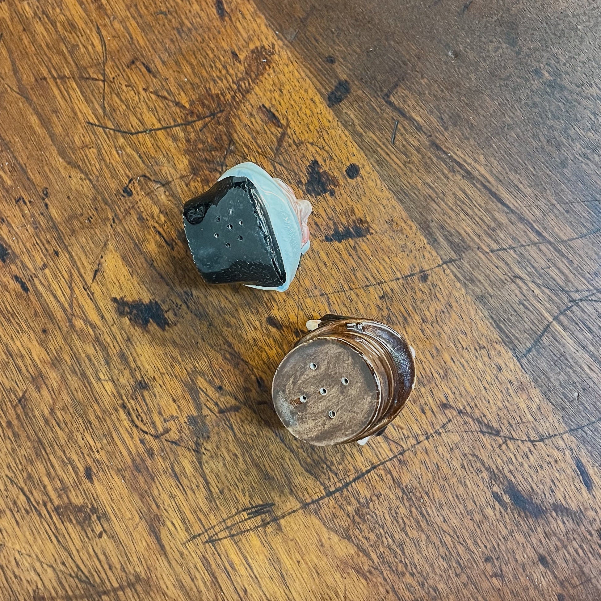 Two small ceramic items on a wooden surface