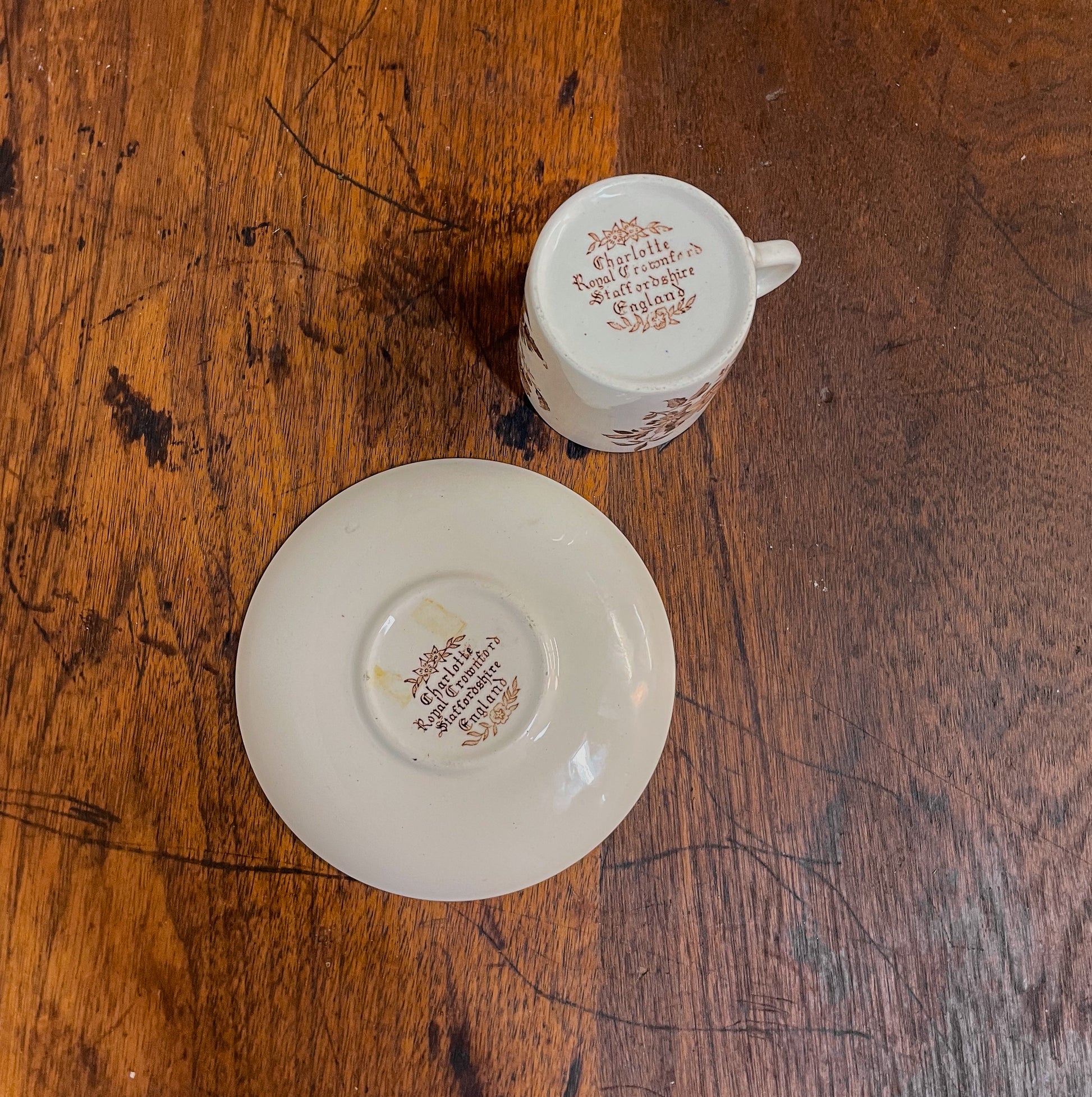 Two ceramic items with text on a wooden surface