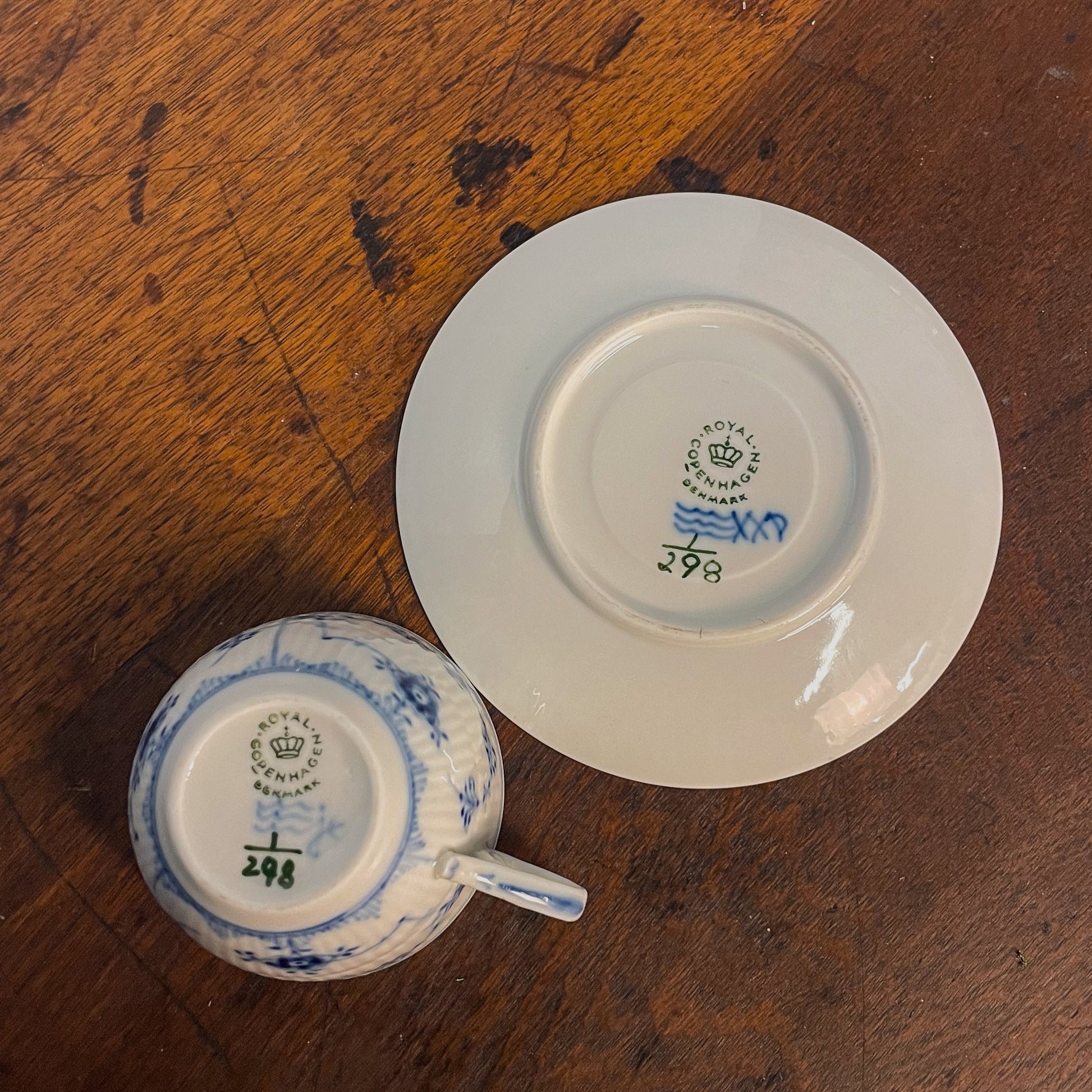 Two ceramic items with visible branding on a wooden surface