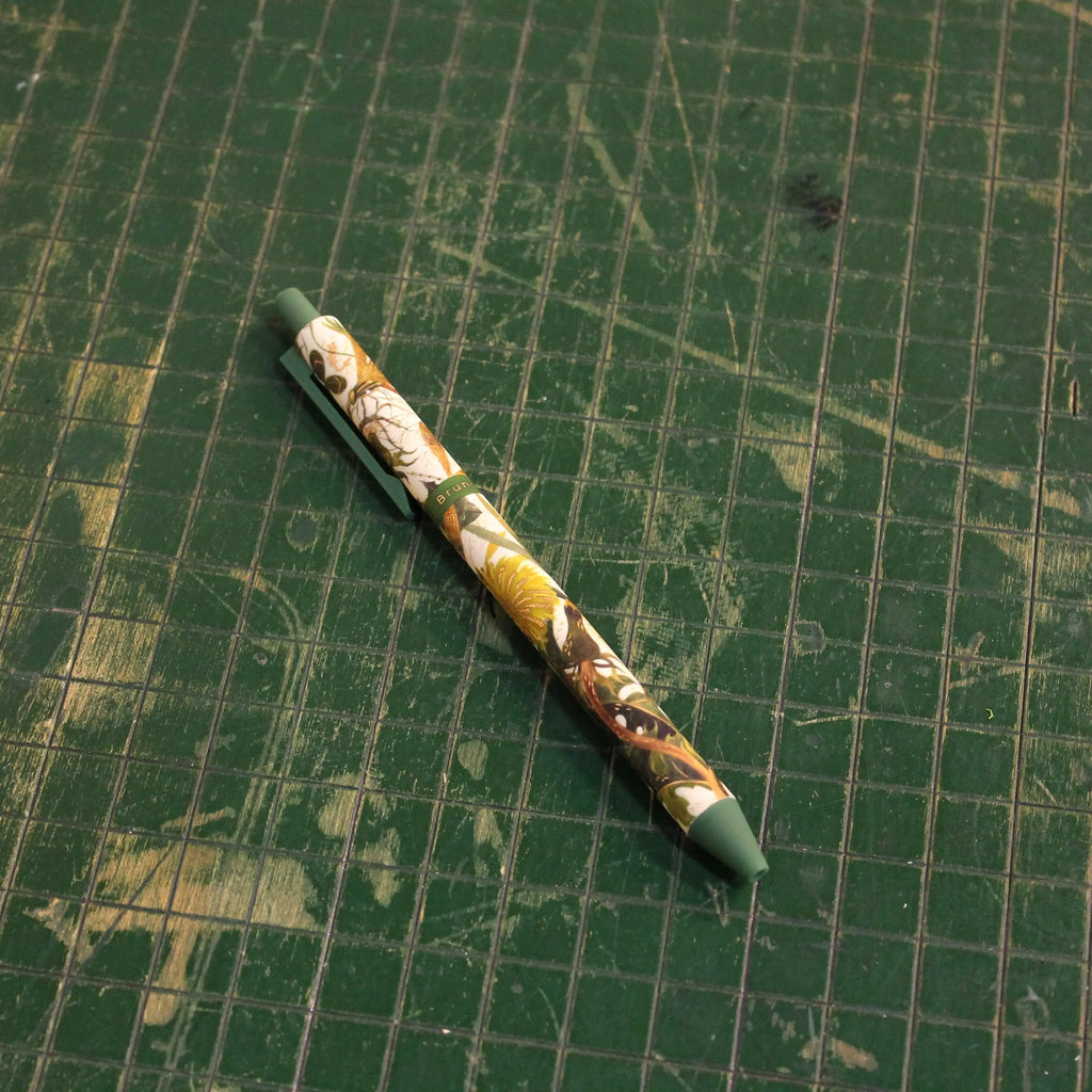 Decorative pen on a green grid background