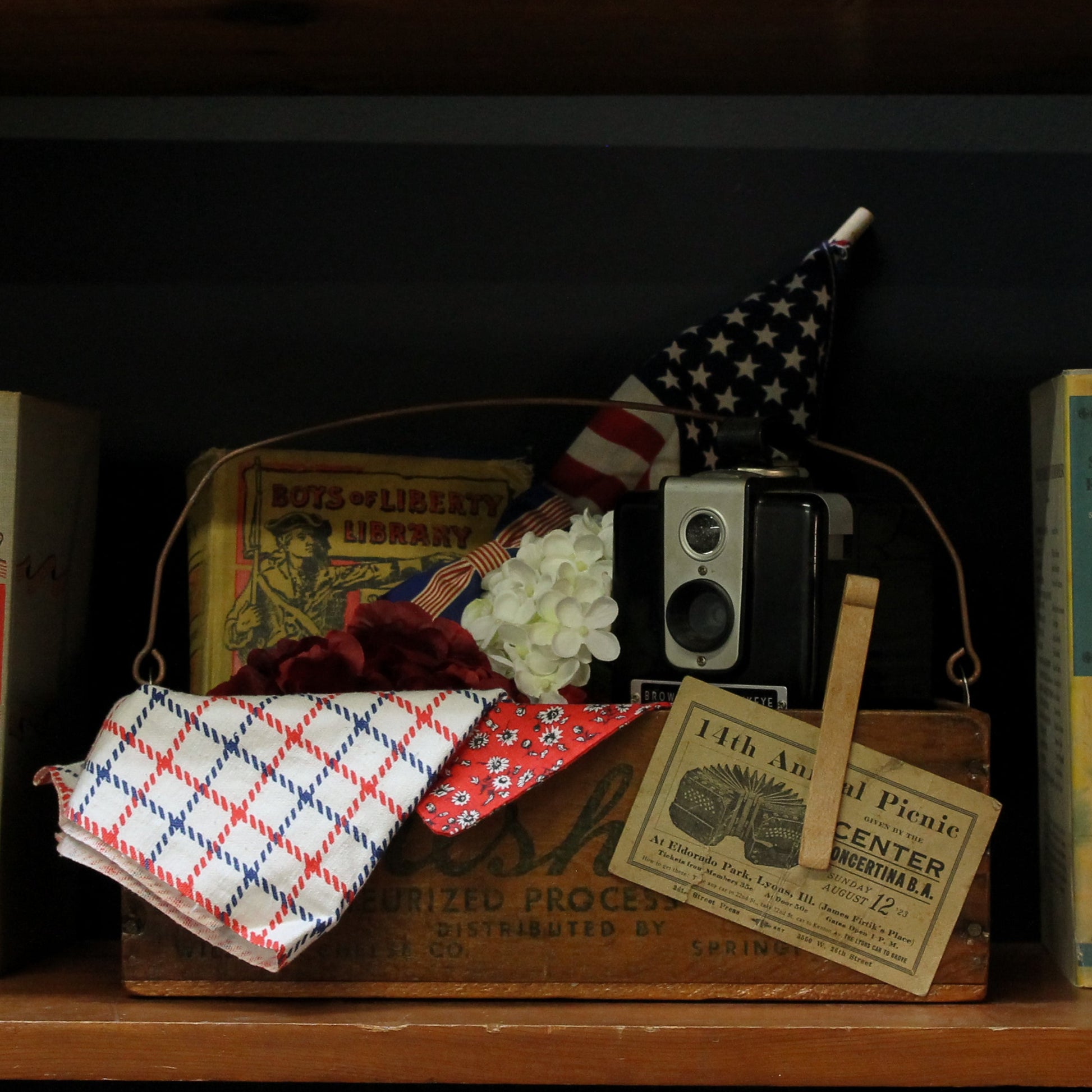 Vintage books and items on a wooden shelf