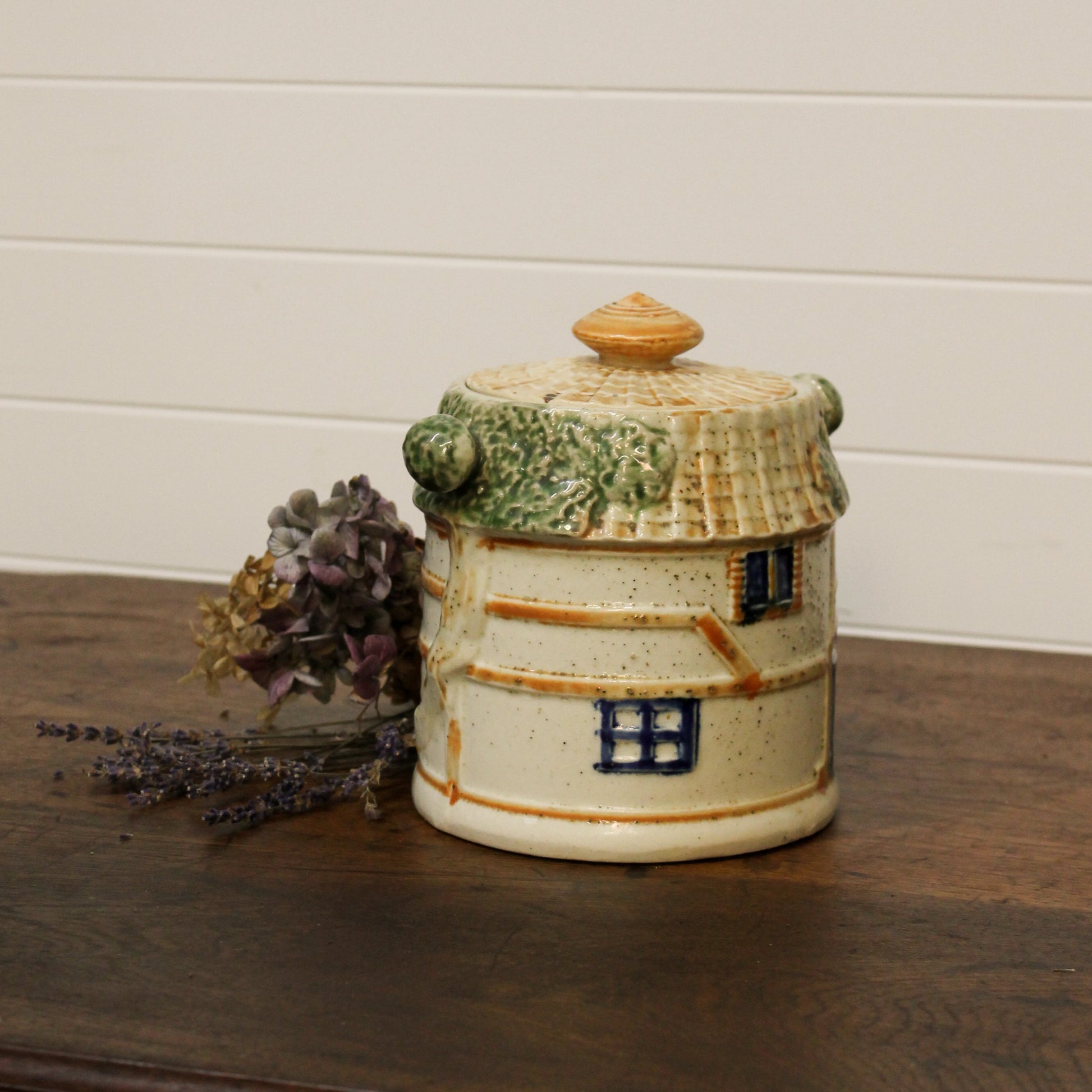 Ceramic jar with a decorative design on a wooden surface