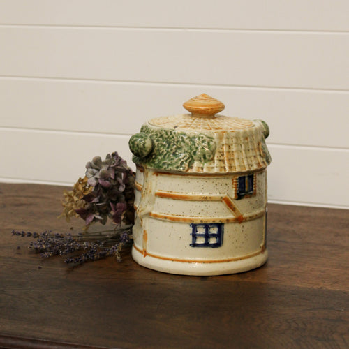 Ceramic jar with a decorative design on a wooden surface